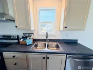 Beautiful dark countertops contrast nicely with the light cabinetry.