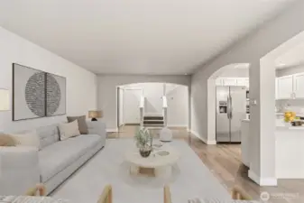 The expansive great room creates a seamless flow and clear sight lines from the kitchen to dining and living spaces. (Virtual Staging)