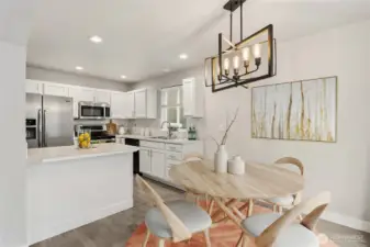 The open kitchen and dining space create an effortless flow between the two spaces, great for ease of serving up delish meals right from the stove top to the dinner table. (Virtual Staging)