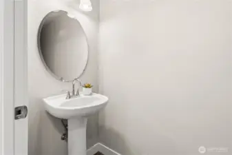 Discreetly tucked around the corner from the great room and on your way to the garage is the main floor powder room.