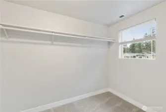 A large picture window allows all the natural light to pour through the expansive walk-in closet.