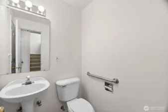 main floor 1/2 bath.  Storage behind door