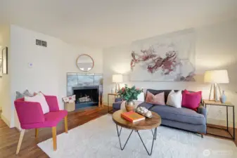 The living room is graced with a cozy fireplace.  Newer LVP flooring is featured throughout.