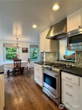 Natural light fills the beautiful kitchen and dining area.