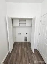 Lots of cabinet storage for laundry room.