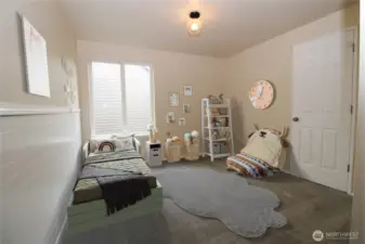 Generous-sized second bedroom upstairs.