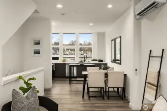 Residential upper floor features window treatments, vinyl flooring, large windows and a minisplit for heating and cooling.
