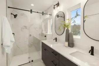 Primary bathroom features a two sink quartz vanity and a ceramic tile walk-in shower