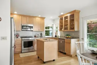 Newer kitchen that is open to dining and main living and door to the covered deck.