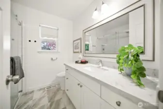 Recently updated bath with walk in  tile shower and quartz counter.