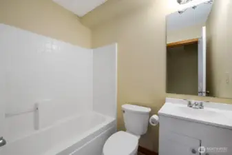 Full Bath on the Entry Level with new Vanity and LVP Flooring.   Next to this Bath is a walk-in Utility Room with brand-new Samsung Washer/Dryer Set.