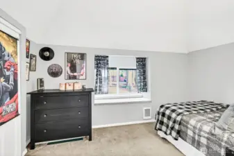 Upstairs leads to 2 of the bedrooms. This secondary bedroom is spacious with a bench window seat with storage