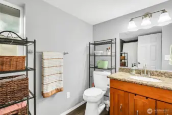 The ensuite bath for the primary bedroom has also been updated with granite counters, lvp floors, newer vanity & fixtures & a tub/shower with a tile surround