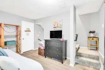 Daylight basement. The stairs lead down to the closet & 3/4 bath. The door leads to the den