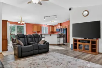 Living room looking into kitchen and back yard