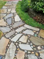 Flagstone and river rock path from main home to caretaker unit