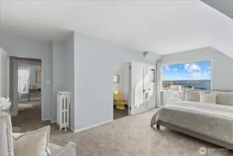 En suite bedroom upstairs captures the view, offers generous size and flexibility.