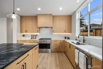 A cooks kitchen, GE Monogram SS appliances, Gas stove and Quartz countertops