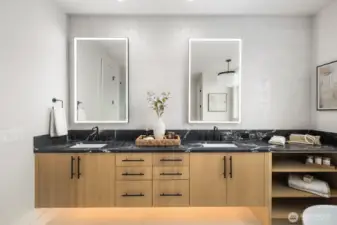 Primary bath with custom cabinet, quartz countertop, fully tiled back space and light mirrors