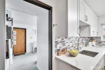 The kitchen also provides access to the shared laundry room and assigned storage unit, though you have your own in-unit laundry upstairs as well.