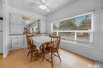 The dining room has a wonderful built-in side bar for plenty of storage and display counter space. A ceiling fan with lighting over the table. Lots of room for a big table.