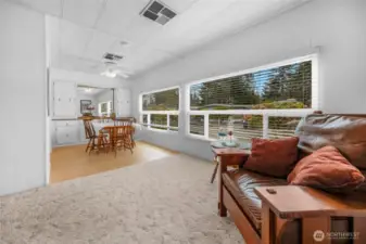 Floor plan in the home has a nice flow. The living room leads to the open dining room area,  A wall of windows that get western exposure.