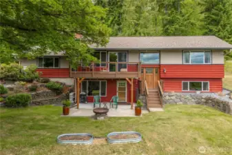 This side of the house shows the patio which is partly covered and partly open. The new Trex deck has an underlayment to the gutter to keep the covered portion of the patio dry. Beautiful rockeries and you can see the separate entrance to the ADU downstairs. The main entrance is on the top floor of the house so it lives like a rambler with a daylight basement.