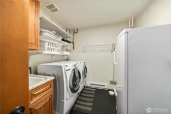 Full laundry room with laundry sink downstairs BUT the main floor primary bedroom suite also has a stacked washer and dryer!