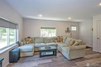 Large window bring the natural light and the new Laminate hardwood flooring throughout the entire home/Natural light pours through large windows, enhancing the beauty of new laminate hardwood flooring that spans the entire home.