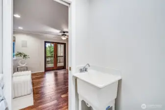 The dedicated main-floor utility room offers essential convenience with space for a washer and dryer, plus overhead cabinetry for storage.