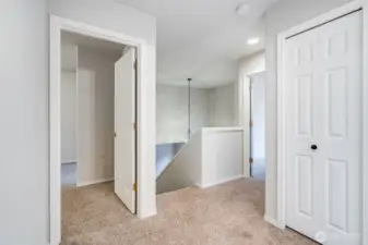 A bright and welcoming second-floor hallway connects all upper-level bedrooms and the full bath. Ample natural light creates an airy, open feeling.