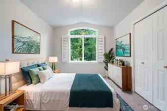 This bright secondary bedroom is situated near the front of the home on the upper level. It offers ample closet space and generous natural light, making it a perfect guest room or child's bedroom.
