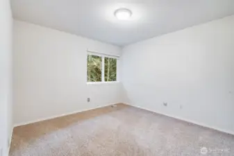 The third upper-level bedroom is quietly positioned toward the back of the house, offering peaceful views of the private backyard. It's an ideal space for a quiet teen retreat or a dedicated upstairs office.