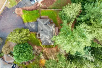 A high-angle drone shot showcasing the large half-acre lot