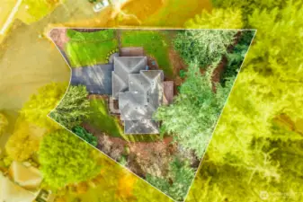 A high-angle drone shot showcasing the large half-acre lot