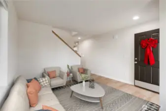 Virtually Staged. Sun-soaked living room highlighted by a large picture windows, crisp new interior paint, and stylish new flooring—creating an airy, welcoming first impression as you step inside.