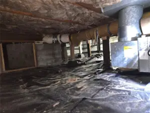 Freshly cleaned crawlspace and vapor barrier