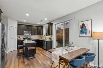 Stainless appliances, granite counters, and dark wood cabinetry make a handsome kitchen