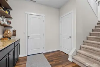 Garage entrance (center), large storage closet, and stairs to the huge upstairs
