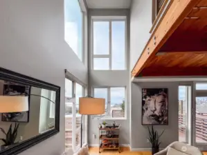 Vaulted ceilings with walls of windows take in the amazing view!
