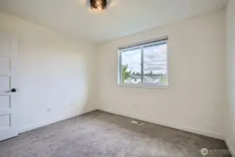 Third bedroom easily fits full-size bed. Don't miss out the treat of having a view of Mount Rainier from this room!