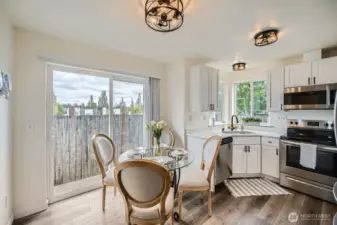 4 OF 5 TOP PHOTOS: Open kitchen with dining area has modern lighting, fixtures, and kitchen with granite countertops and stainless steel appliances.