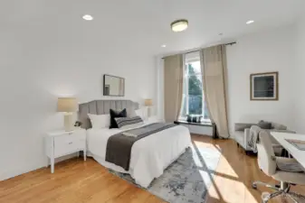 Primary bedroom oversized windows face west