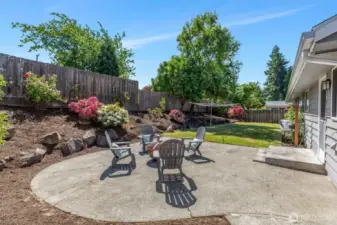 What a great patio!  Room for picnic table and chairs, BBQ, Fire pit, chaise lounge!  Perennial bushes with blooming color.
