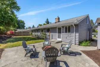Fabulous flat back yard with room for a swing set or play structure.  How fun to have a classic laundry clothes line to get that super fresh fragrance on sheets!