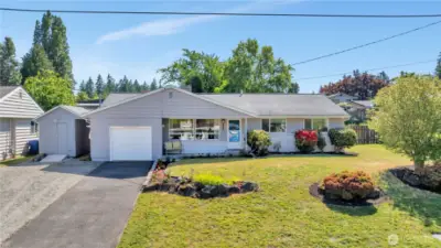 The structure to the immediate left of the house and garage with a small ramp has power.  It's a great bonus storage area for lawn equipment, garden supplies, bikes, sports gear, and other seasonal supplies.  The graveled parking area in front of the storage structure is easily used for additional off-street parking.