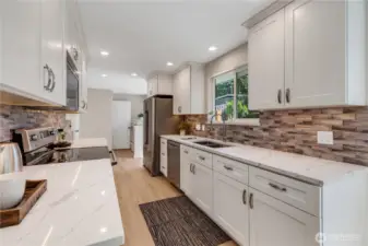 Stainless appliances and a deep 2-bay sink make this kitchen efficient and a delight to prepare meals.  Expansive counter space for serving, Holiday baking, and room for extra help in the kitchen!