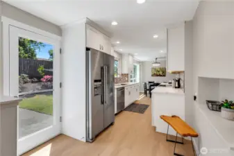 Kitchen door to the back yard steps out to the Patio, and easy access to the BBQ.  Niche seating area above could be a planner desk, study table, or add a U-line Beverage frig for juice boxes or other drinks.