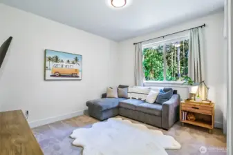 Bedroom or game room with a view of the forest and garden