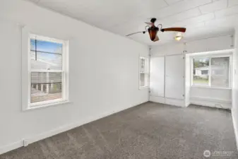 Primary bedroom with great light and ceiling fan.